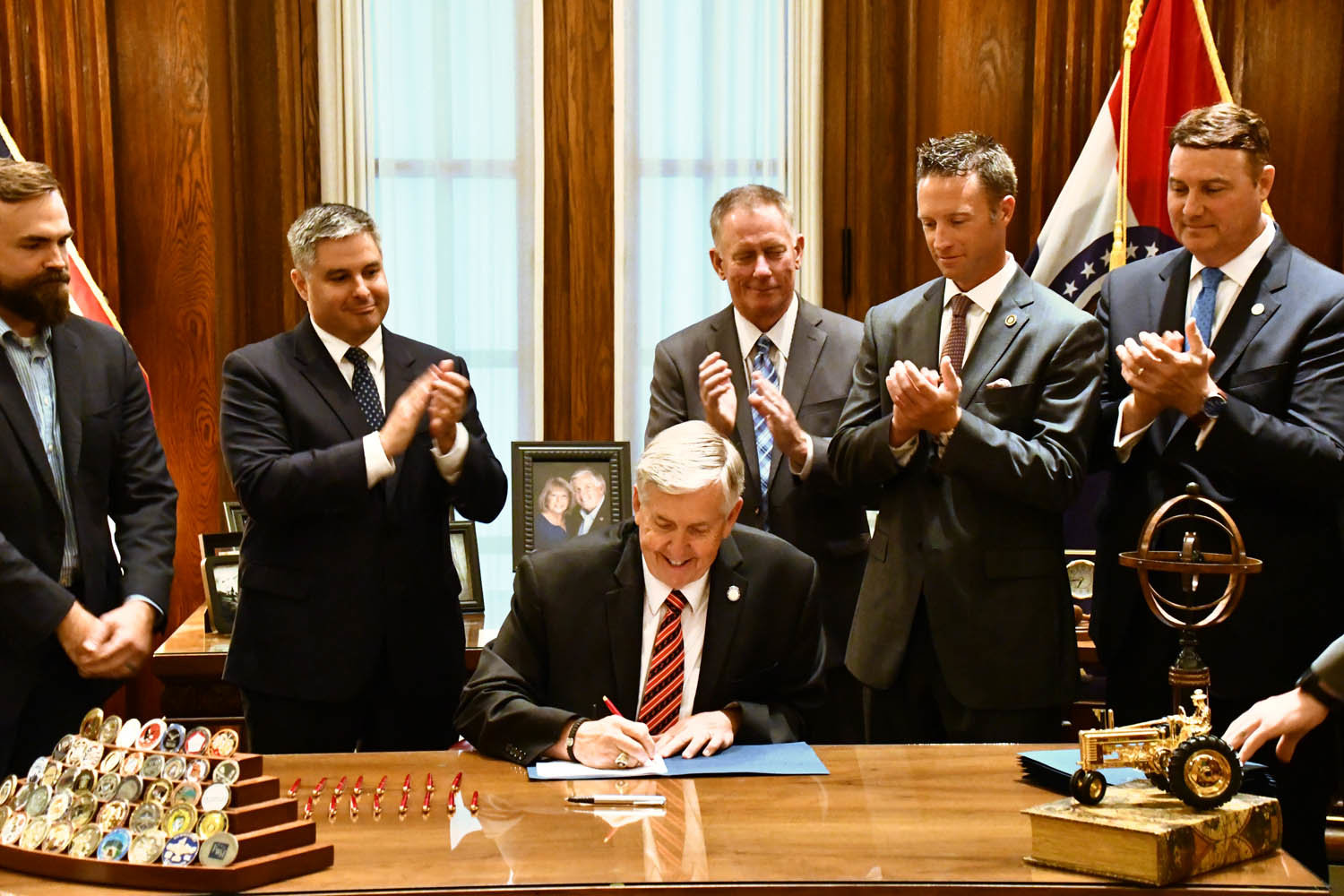 Missouri Gov. Mike Parson signs Senate Bill 68 after legislators passed it in May.